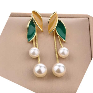 A pair of gold earrings with green and brown leaves and dangling pearls.